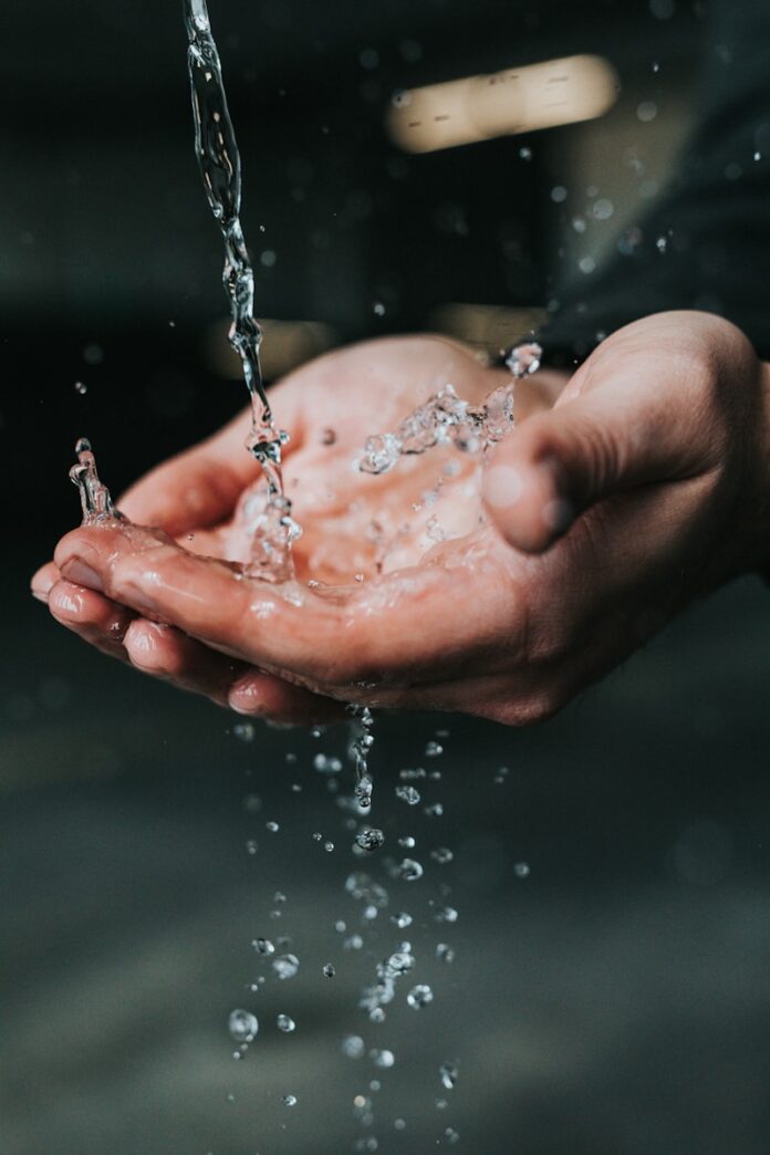 Photo by Nathan Dumlao clear liquid pouring on person's hands