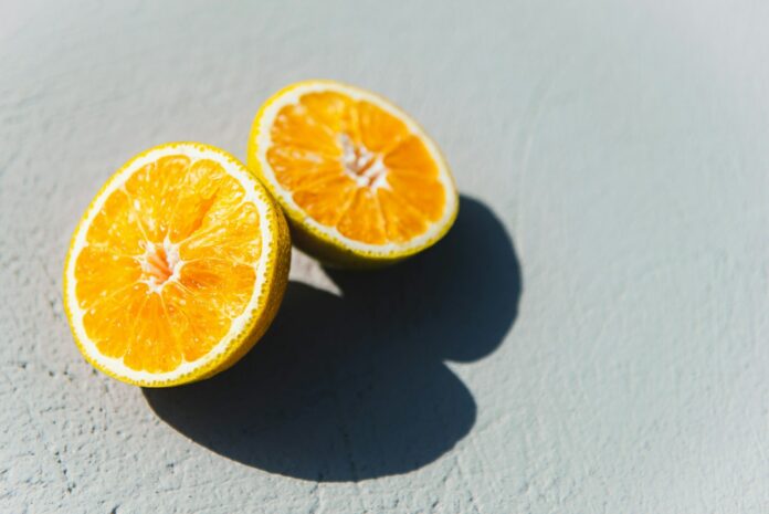 Photo by Anastasiia Chepinska two oranges cut in half sitting on a table