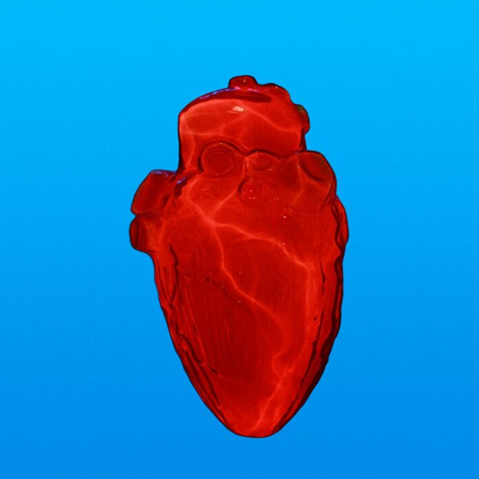 Photo by benjamin lehman a red heart shaped object floating in the air
