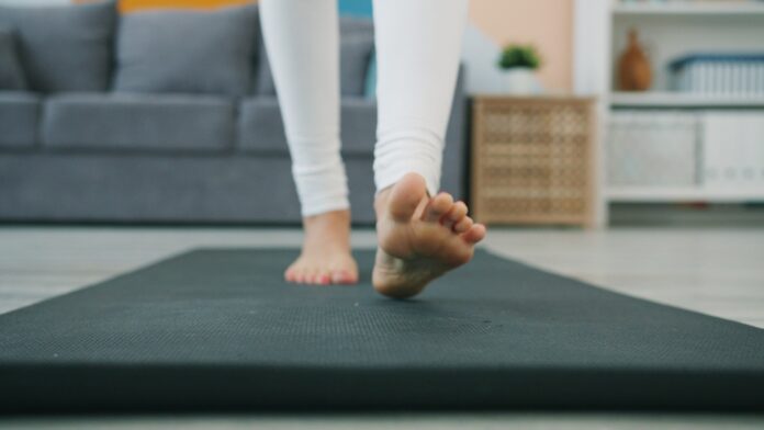 Bare feet walking on a yoga mat