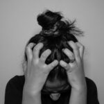 일상 속 스트레스, 작지만 확실한 실천으로 관리한다 a woman covering her face with her hands