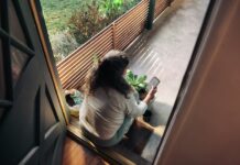 만성피로, 생활 습관 바꾸기로 ‘탈출’ 가능할까? Woman sitting on balcony with smartphone