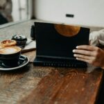 디지털 디톡스, 일상 속 실천법으로 스마트폰 피로 줄이기 a woman sitting at a table using a laptop computer